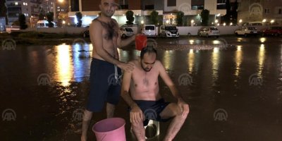 İZMİR'DE SU KESİNTİSİNE DİKKAT ÇEKMEK İÇİN SOKAKTA YIKANDILAR